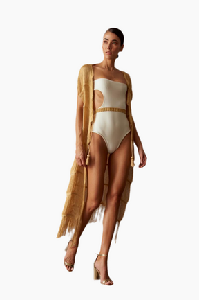Woman wearing a beige swimsuit with a matching cover-up 