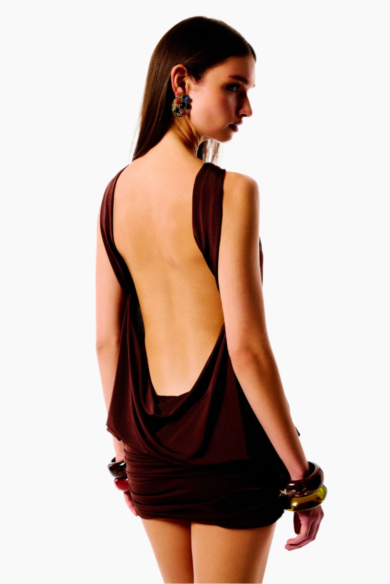 Woman wearing a brown dress with an open back 