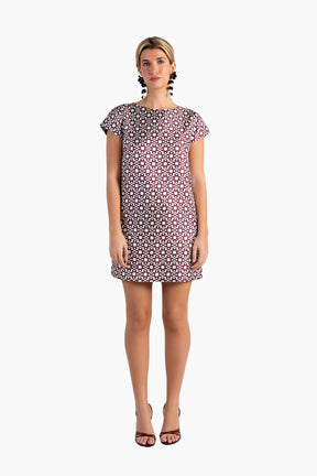 Woman wearing a patterned dress on a white background
