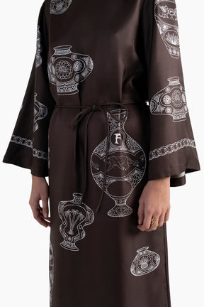 Brown dress with black and white pattern on a white background