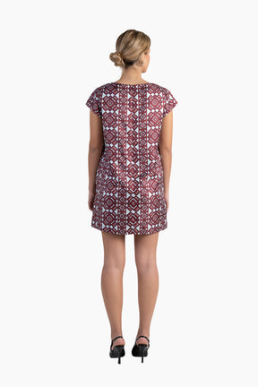 Woman wearing a patterned dress on a white background