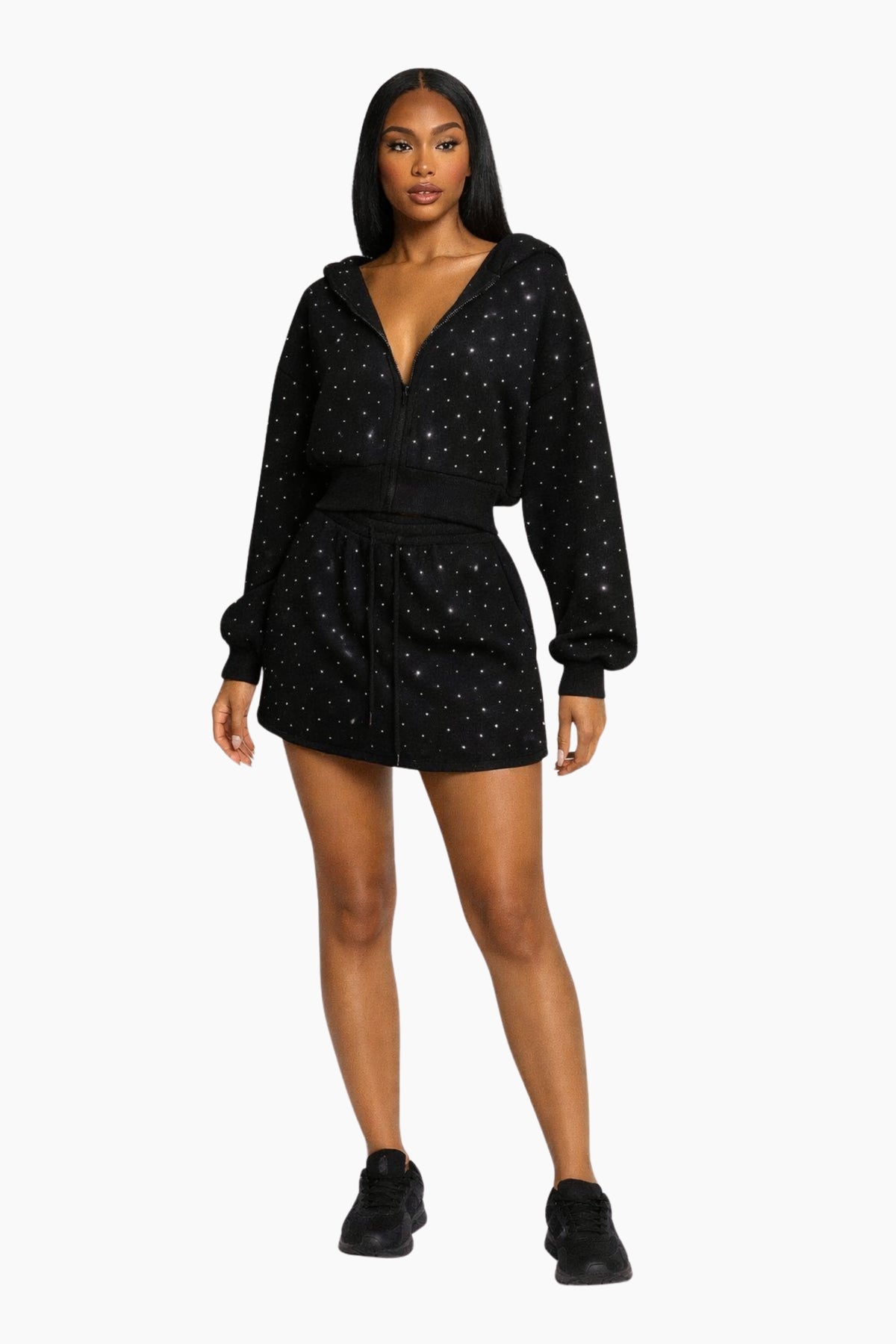 Woman wearing a black outfit with star patterns on a white background