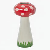 Mushroom-shaped vase with red cap, white spots, and green base 