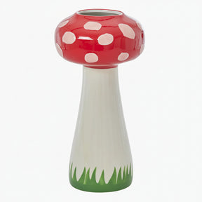 Mushroom-shaped vase with red cap, white spots, and green base 