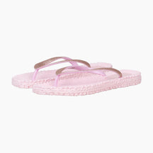 Pair of pink sandals with gold straps on a white background