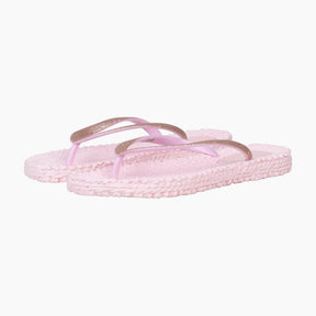 Pair of pink sandals with gold straps on a white background