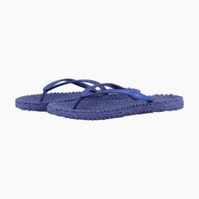 Pair of blue flip-flops on a white background