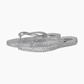 Silver flip-flops with rhinestone embellishments on a white background