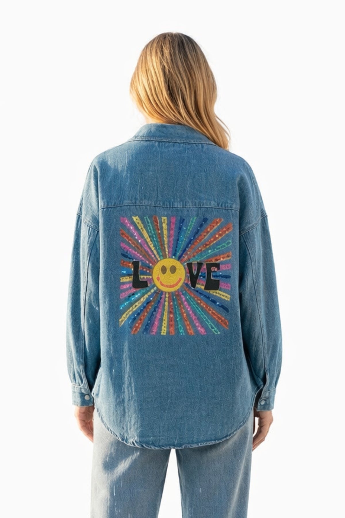Person wearing a blue denim jacket with a colorful 'LOVE' design on the back against a white background