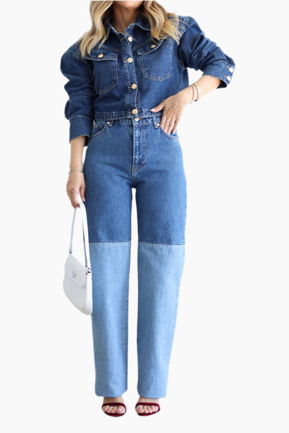 Person wearing a denim jumpsuit on a white background