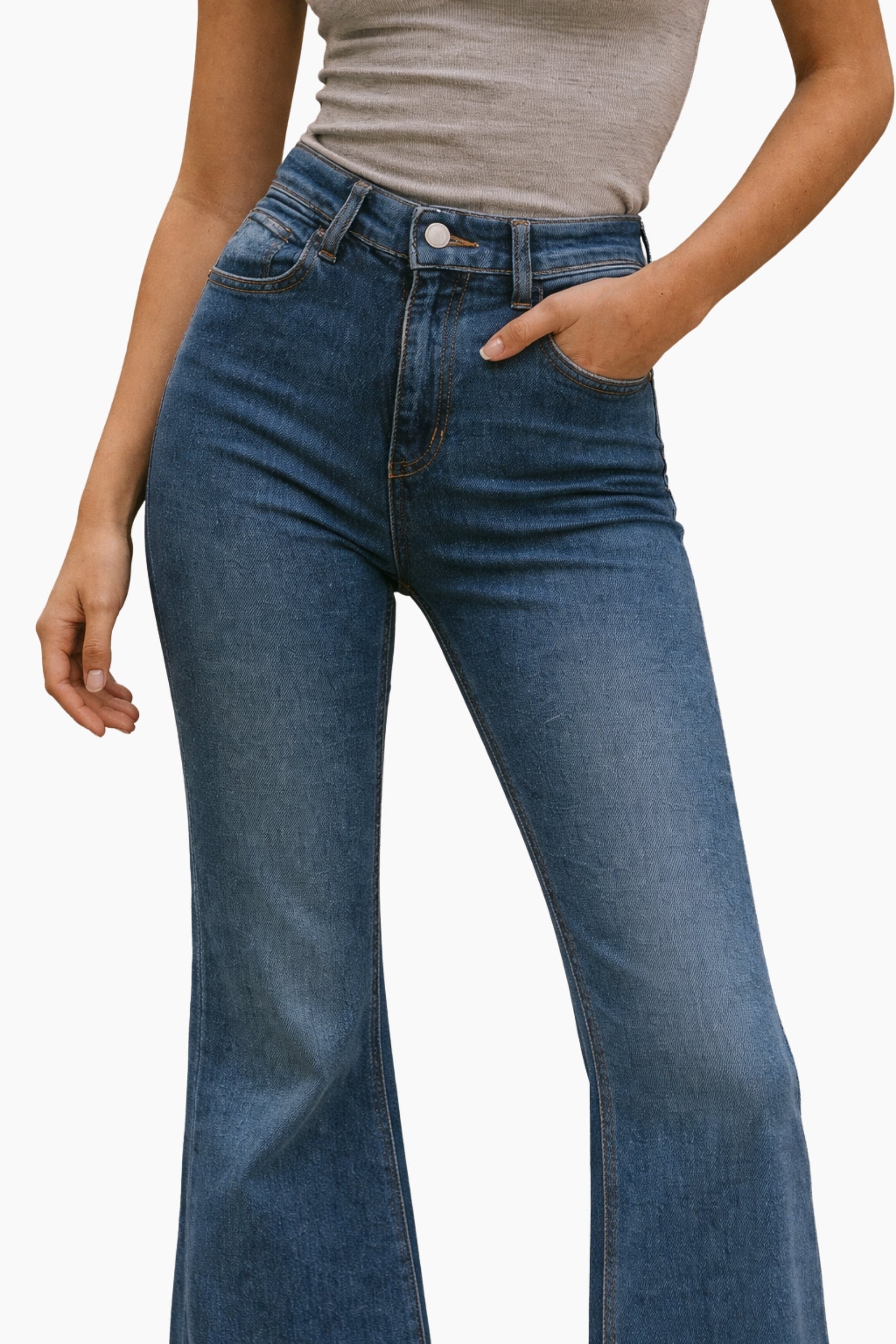 Person wearing blue jeans and a gray top on a white background