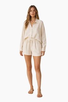 Woman wearing a beige outfit on a white background