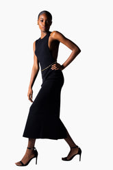 a black open back, halter neckline and a thigh-high slit dress.
