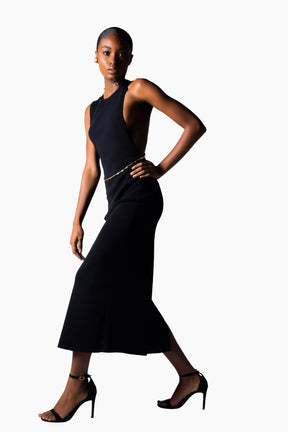 a black open back, halter neckline and a thigh-high slit dress.
