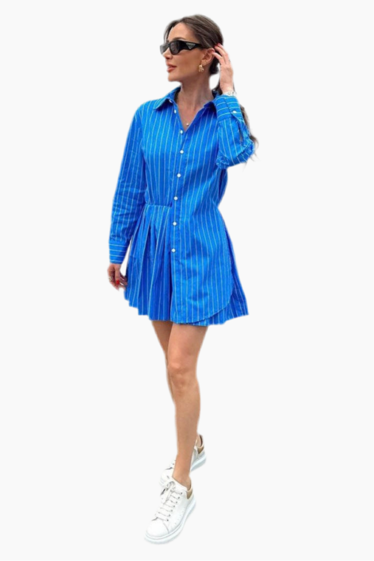 Woman wearing a blue striped dress on a white background