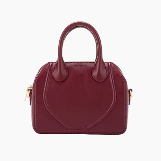 Burgundy handbag with gold accents on a white background
