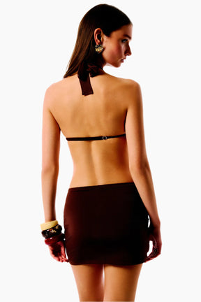 Woman wearing a black halter top and skirt 