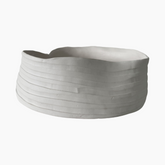 Gray ceramic planter with wavy design on a white background