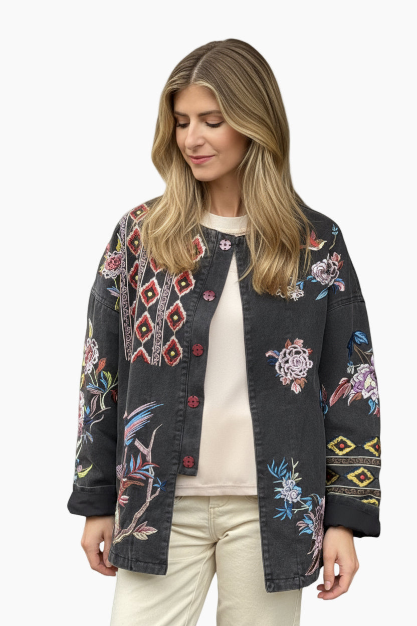 Woman wearing a black floral embroidered jacket 