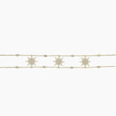 Gold bracelet with star-shaped charms on a white background