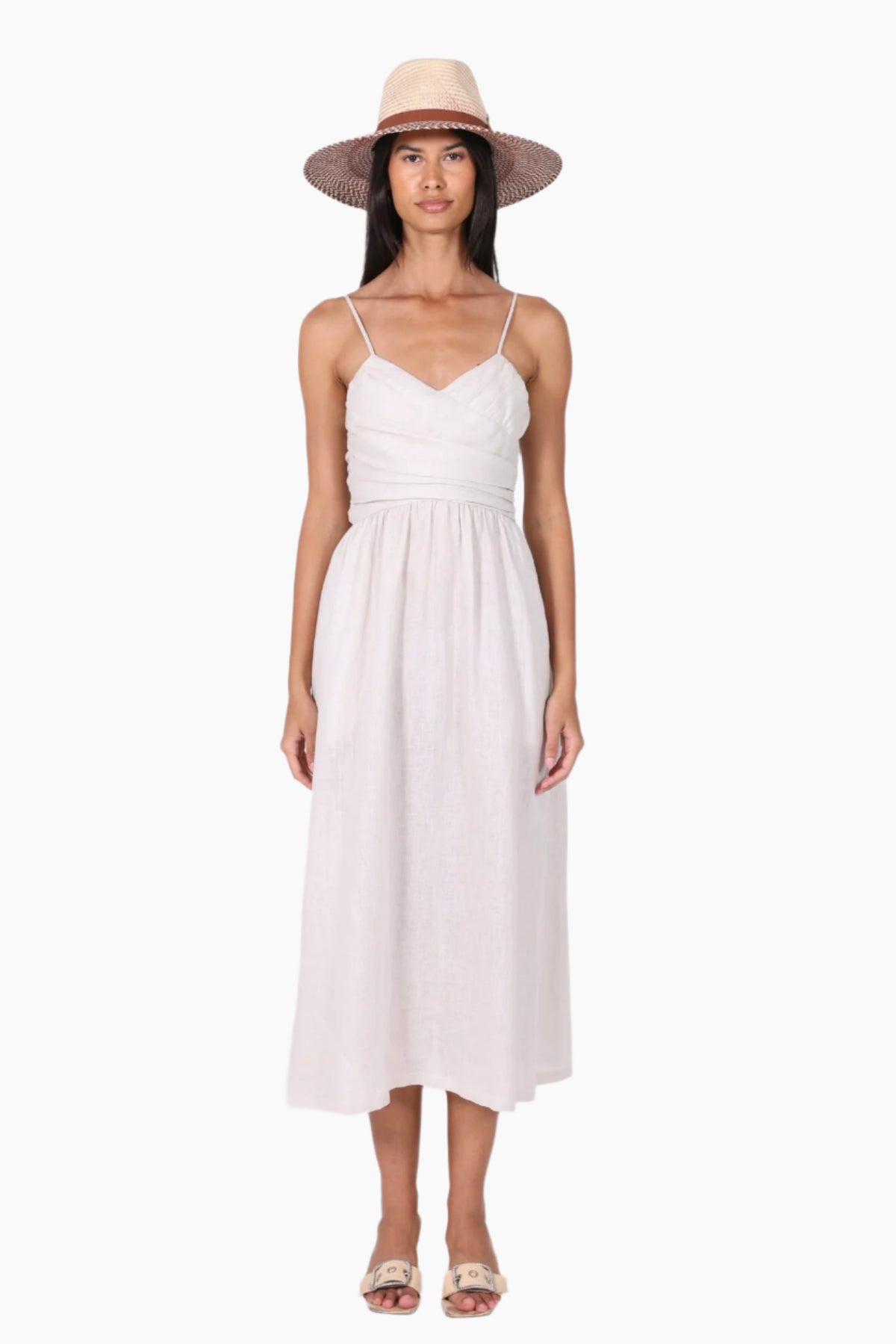 Woman wearing a white dress and straw hat 