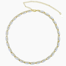 Necklace with gold and white beads on a white background