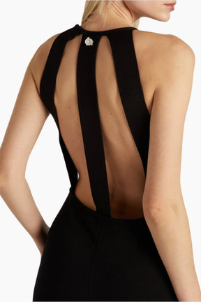 Black dress with sheer back panels worn by a model 