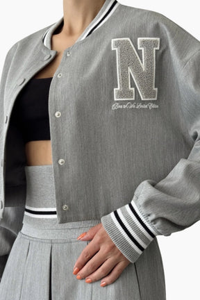 Gray varsity jacket with a large 'N' logo on a white background