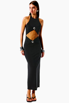 Woman wearing a black halter neck dress with cut-out design 