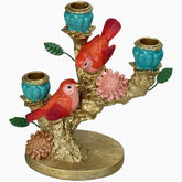 Decorative candle holder with red birds, blue vases, and pink flowers 
