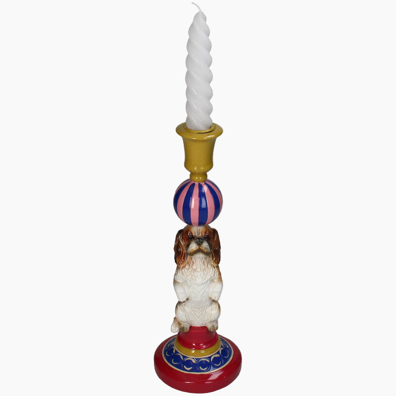 Decorative candle holder with a dog figurine, striped ball, and colorful base 