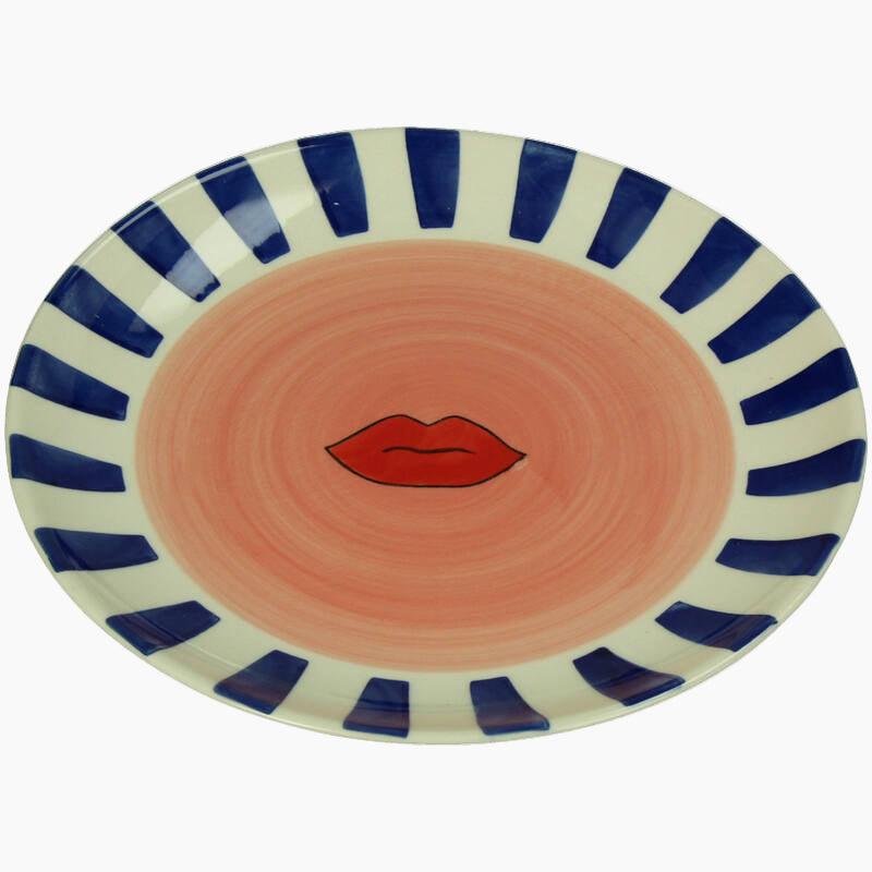 Ceramic plate with blue and white striped rim and red lips design 