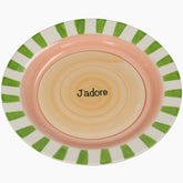 Ceramic plate with green striped rim and 'J dore' text 