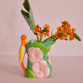Decorative ceramic pitcher with floral design and orange flowers 