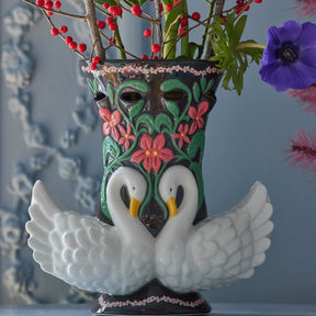 Decorative vase with swan design and floral patterns