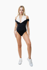 Woman wearing a black and white Swim Bodysuit 
