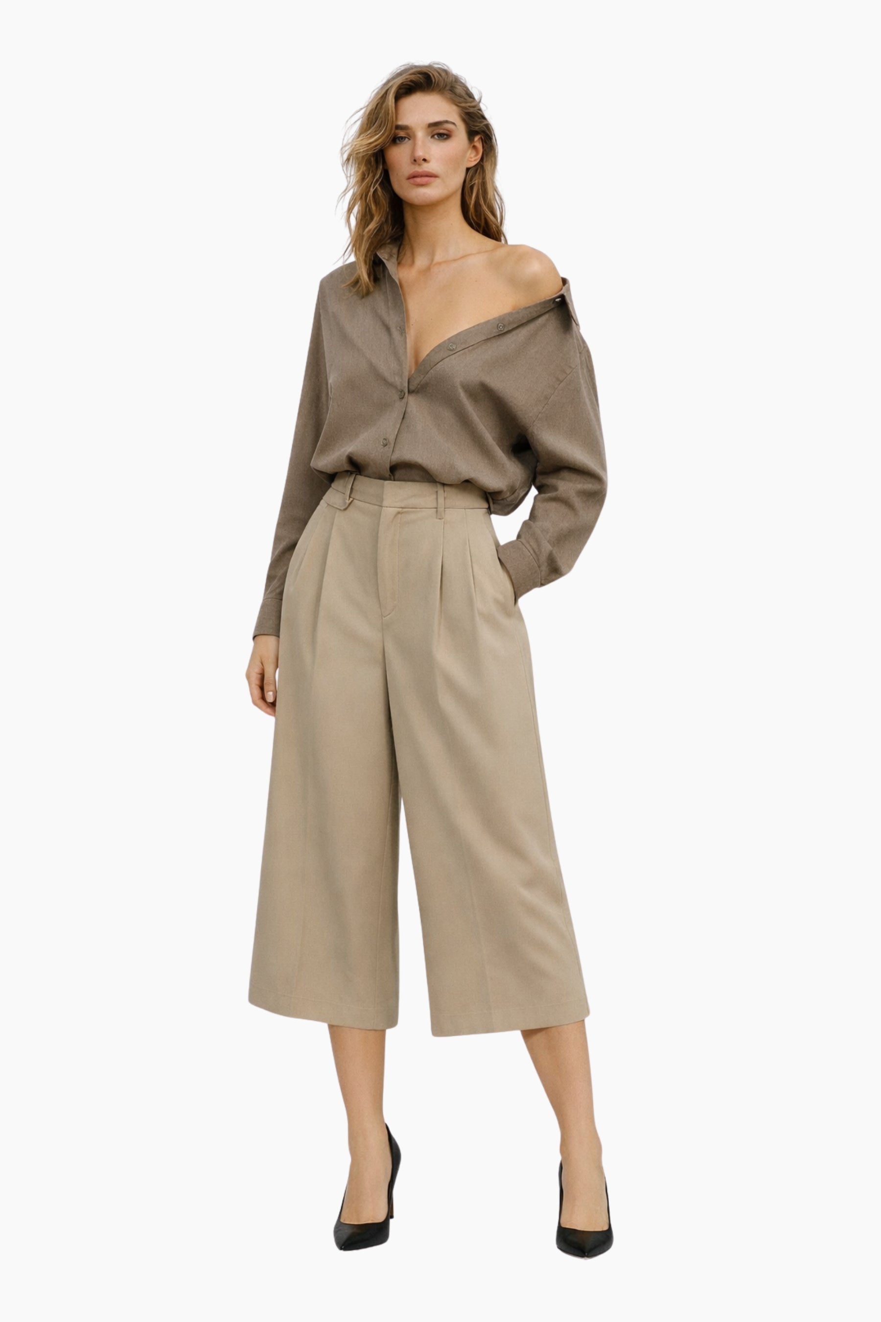 Woman wearing a beige off-shoulder top and wide-leg pants on a white background