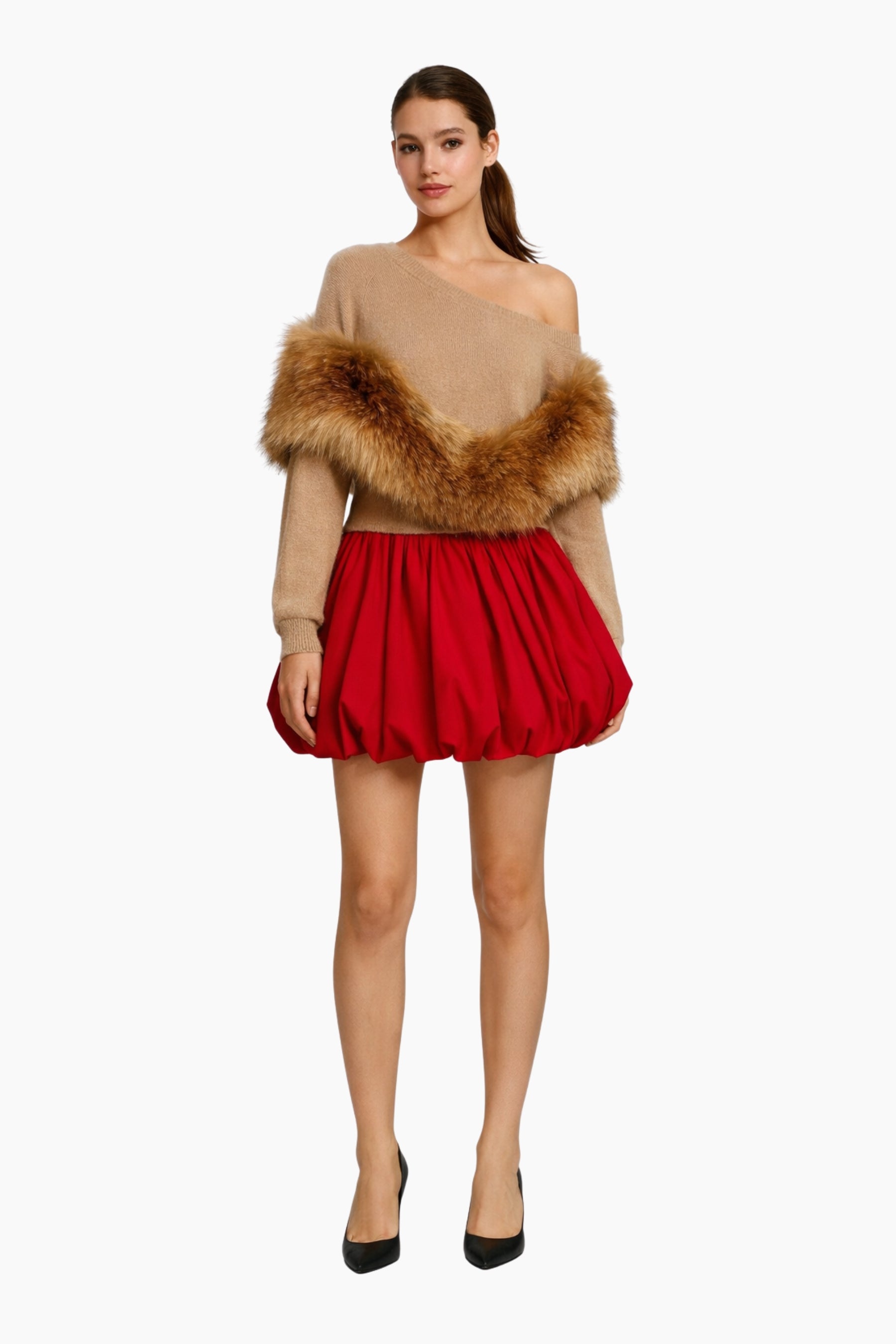 Woman wearing a beige off-shoulder top with fur trim and a red skirt on a white background