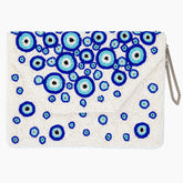 White clutch with blue and green circular patterns on a white background