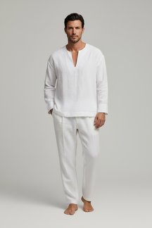 Man wearing a white linen shirt and pants on a gray background