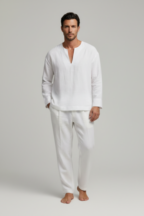 Man wearing a white linen shirt and pants on a gray background