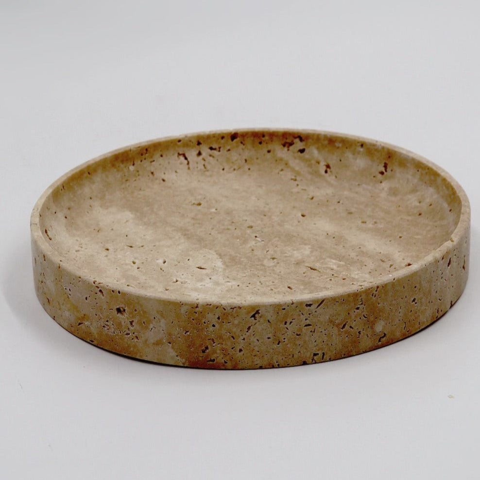 Round ceramic dish with a textured surface on a white background