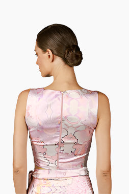 Woman wearing a pink floral sleeveless top, back zipper , with a matching skirt