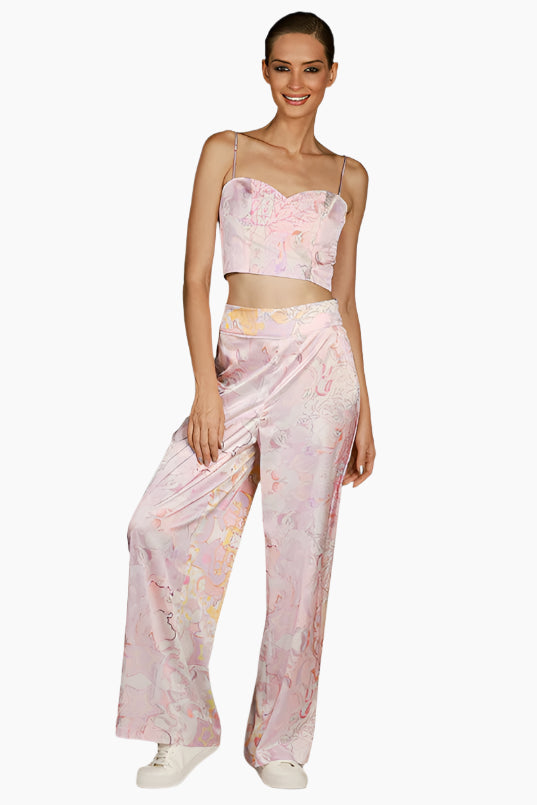 Woman wearing a floral top and pants pants with matching tops