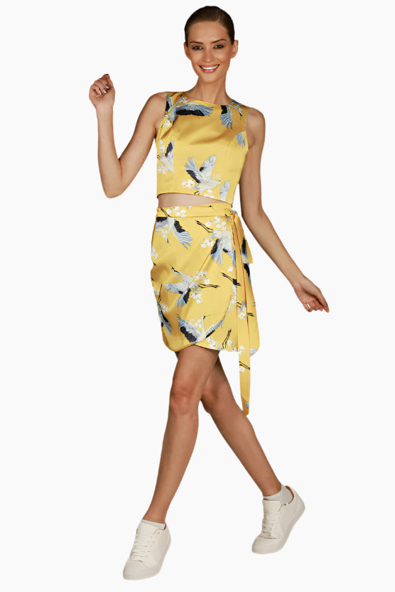 Woman wearing a yellow floral skirt and top matching set