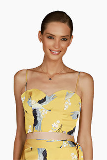 Woman wearing a yellow floral top