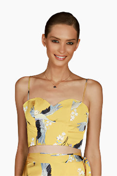Woman wearing a yellow floral top