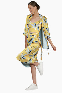 Woman wearing a yellow floral  outfit skirt, top and kimono 