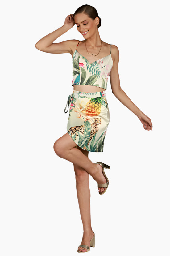 Woman wearing a tropical print two-piece outfit , skirt and top matching set