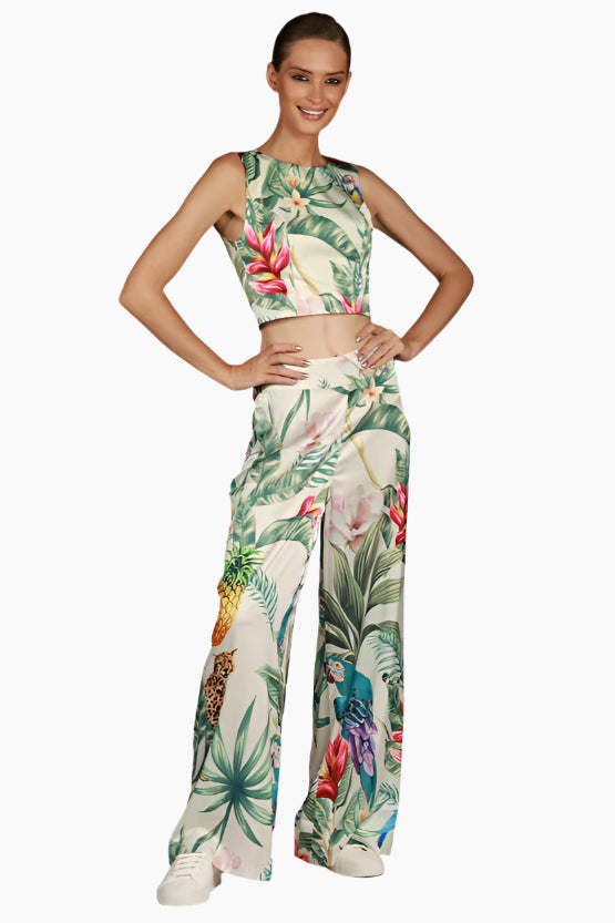 Model wearing a tropical floral d pants with matching tops